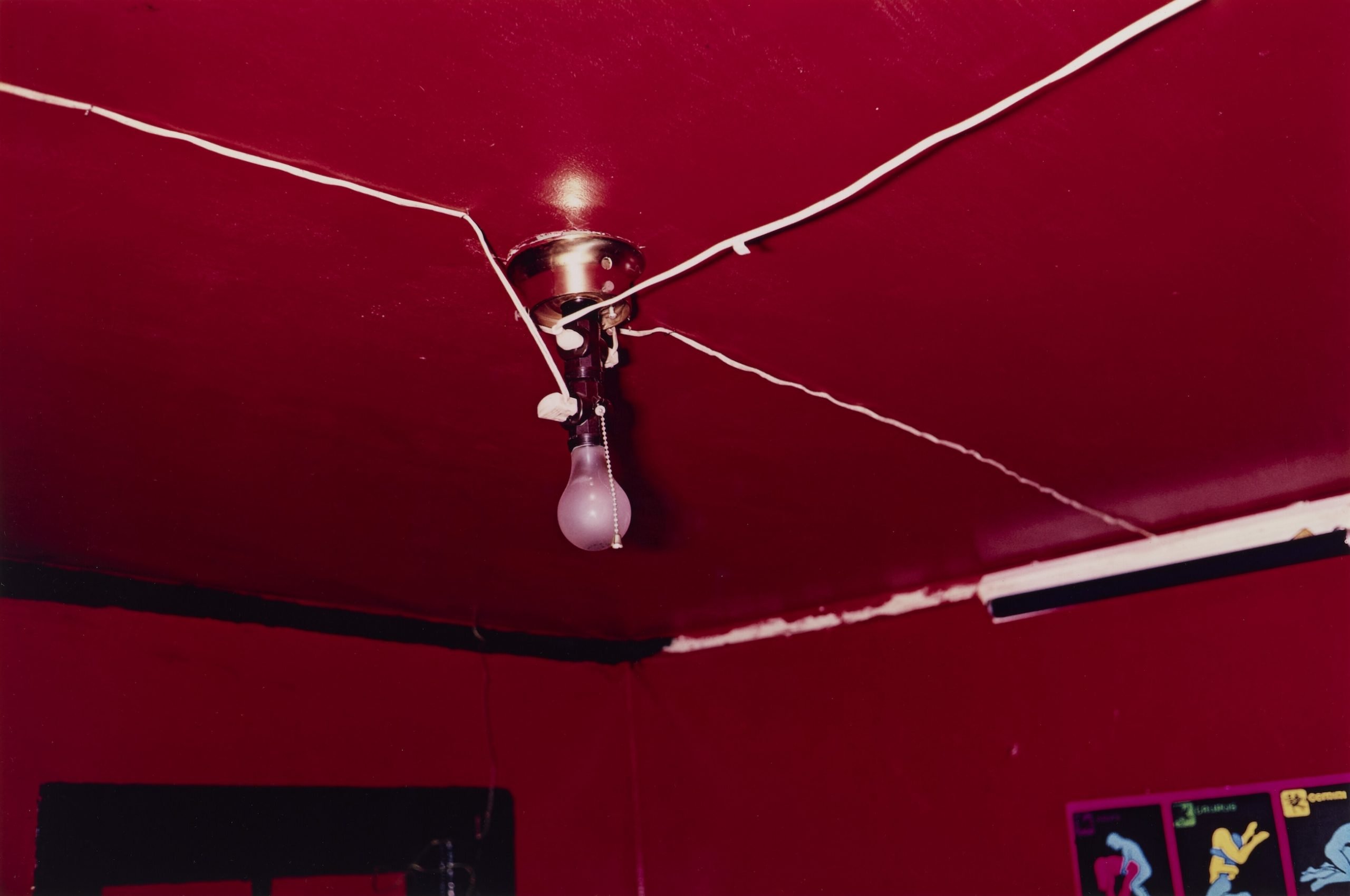 A photograph of the ceiling of a room painted bright red