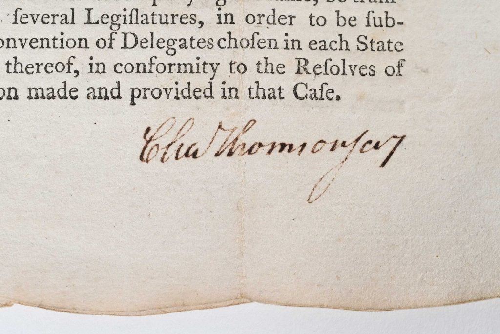 a close up of a page with a signature at the botto 