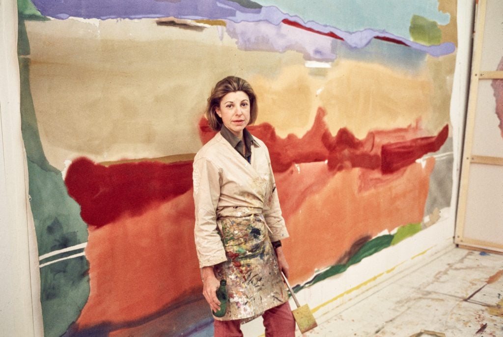 Artist Helen Frankenthaler stands in front of her painting