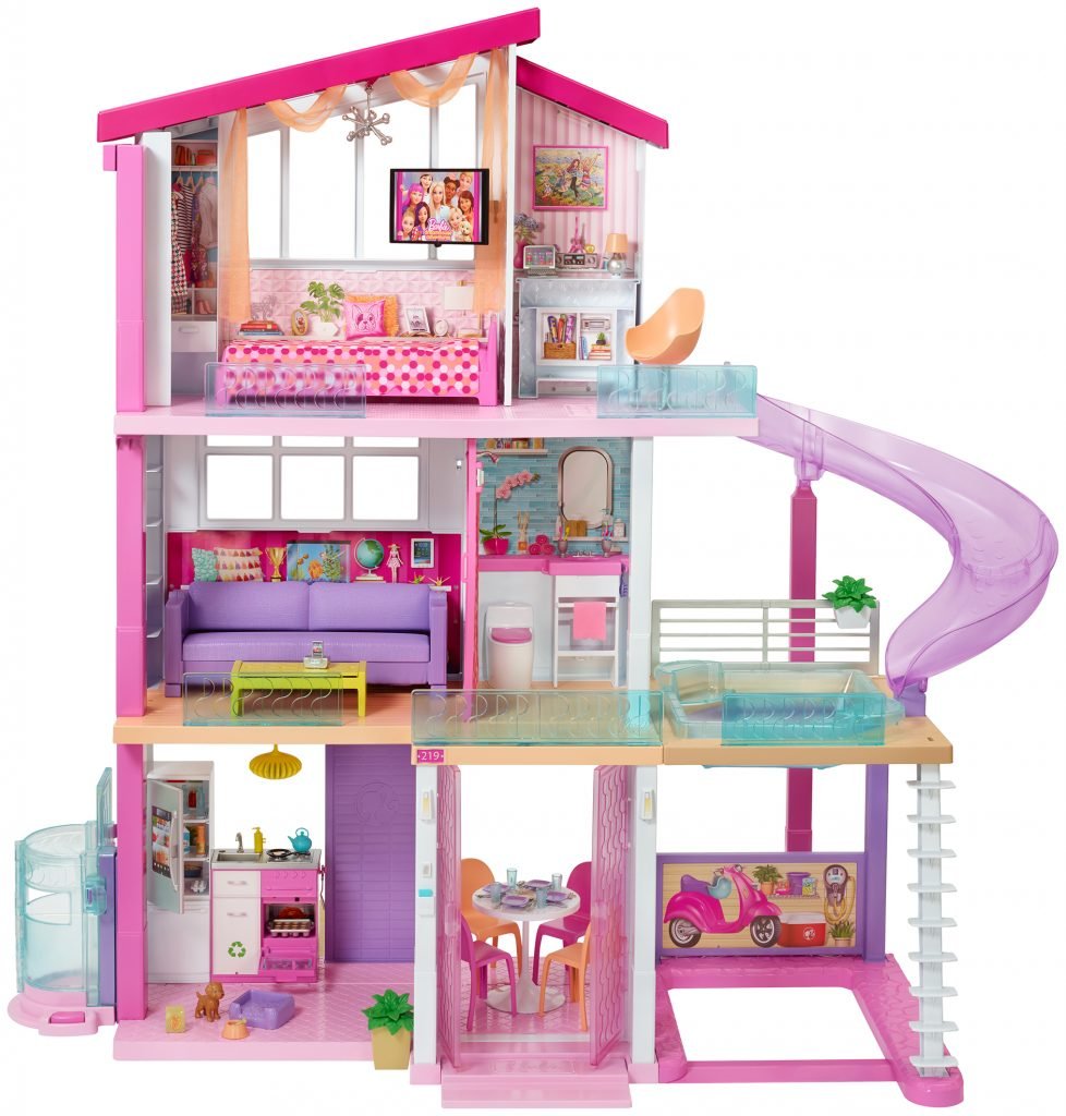 A photograph of a three-story 2018 Barbie DreamHouse, all done up in pink, with a translucent pink slide off its right — all on a white background