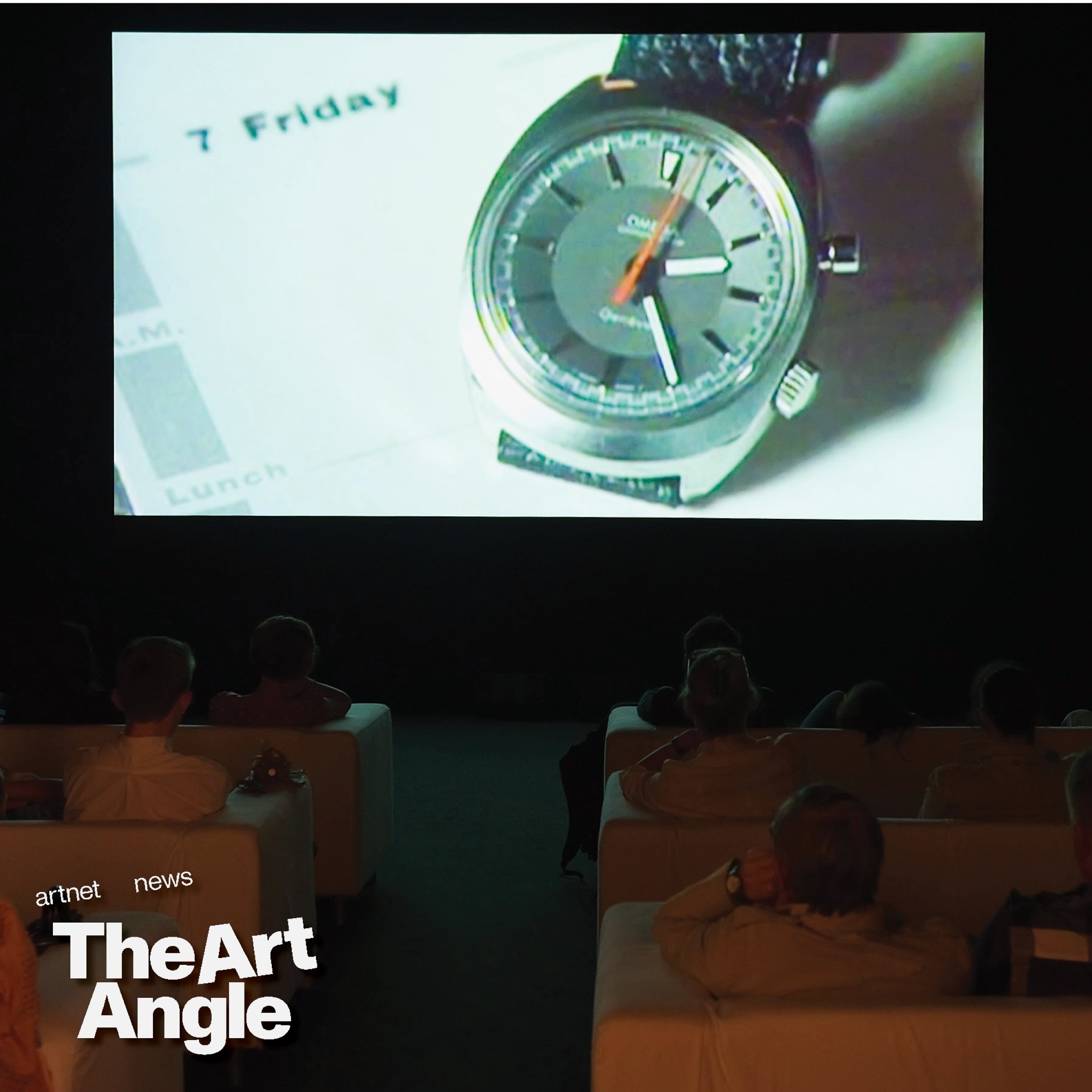 a video screen shows the words '7 friday' next to a wristwatch