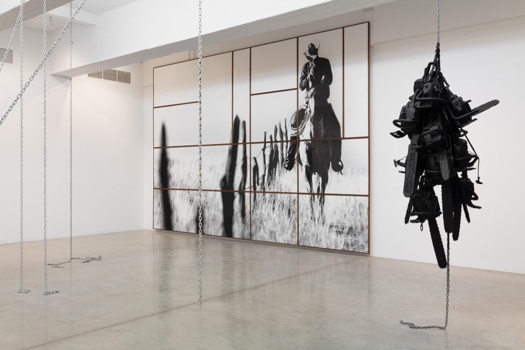 Installation view of work that includes a big stencil of the Marlboro Man by Monica Bonvicini