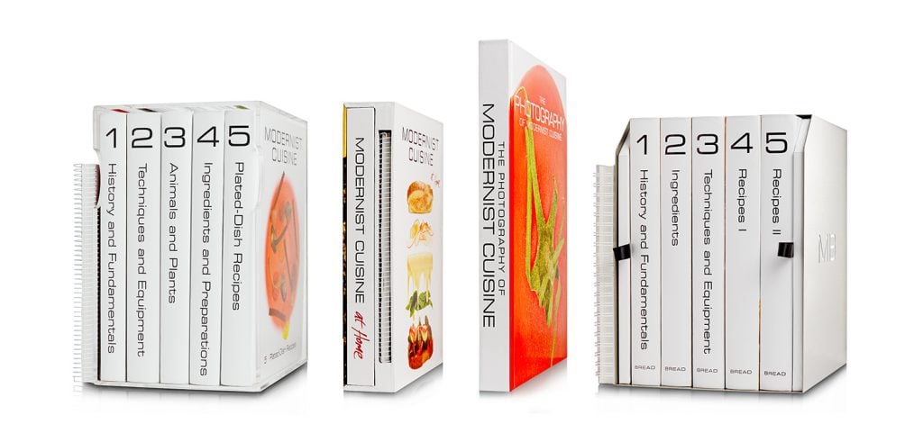 The Modernist Cuisine books. There are several box sets of large glossy cookbooks with white covers photographed on a white background.