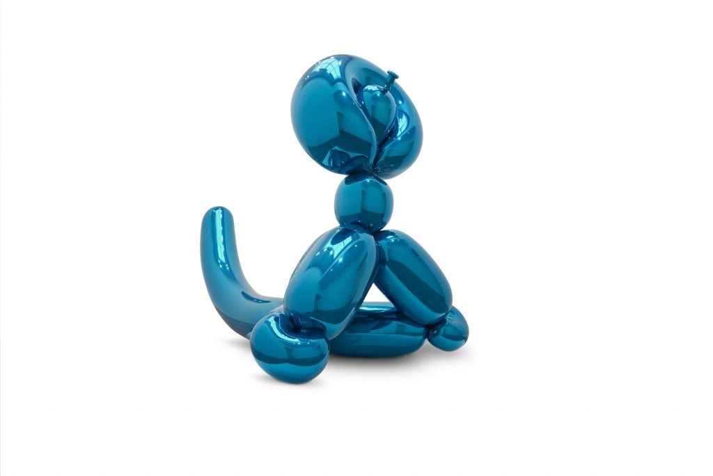 an image of a blue stainless steel balloon sculpture of a monkey