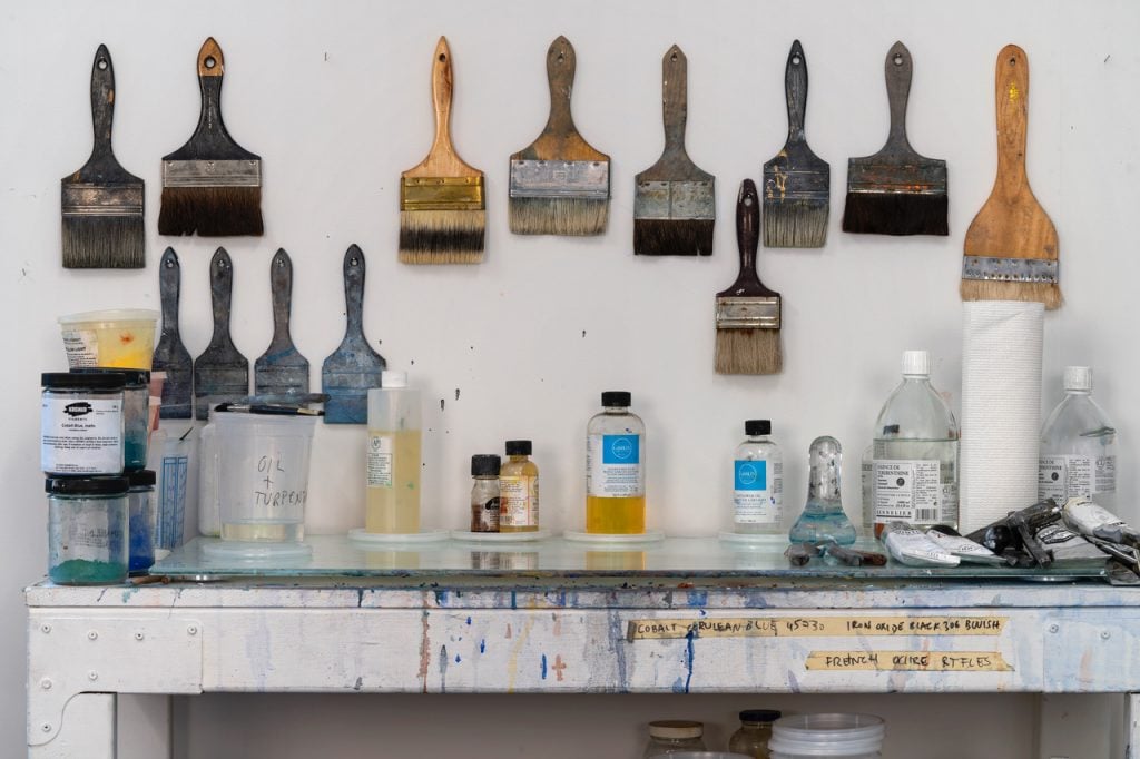 paintbrushes and solvents in an artist studio