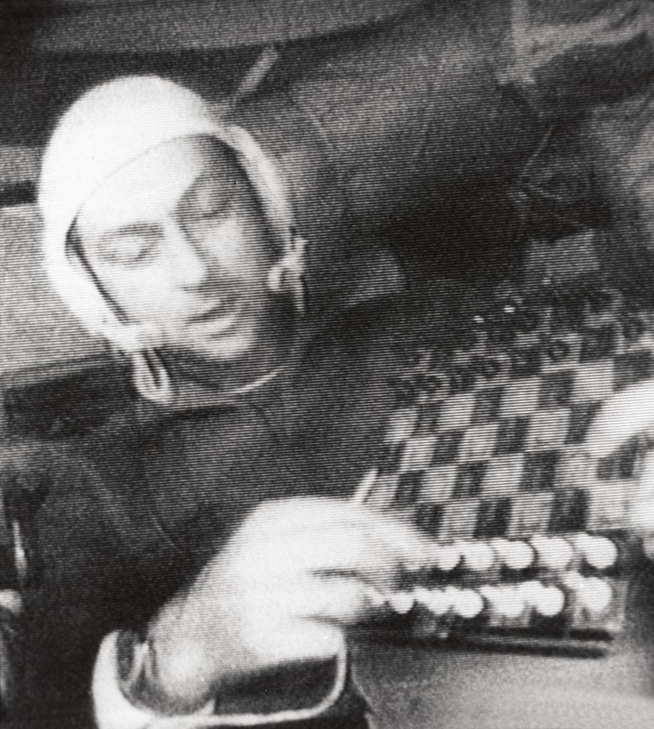 a man in space plays a game of chess