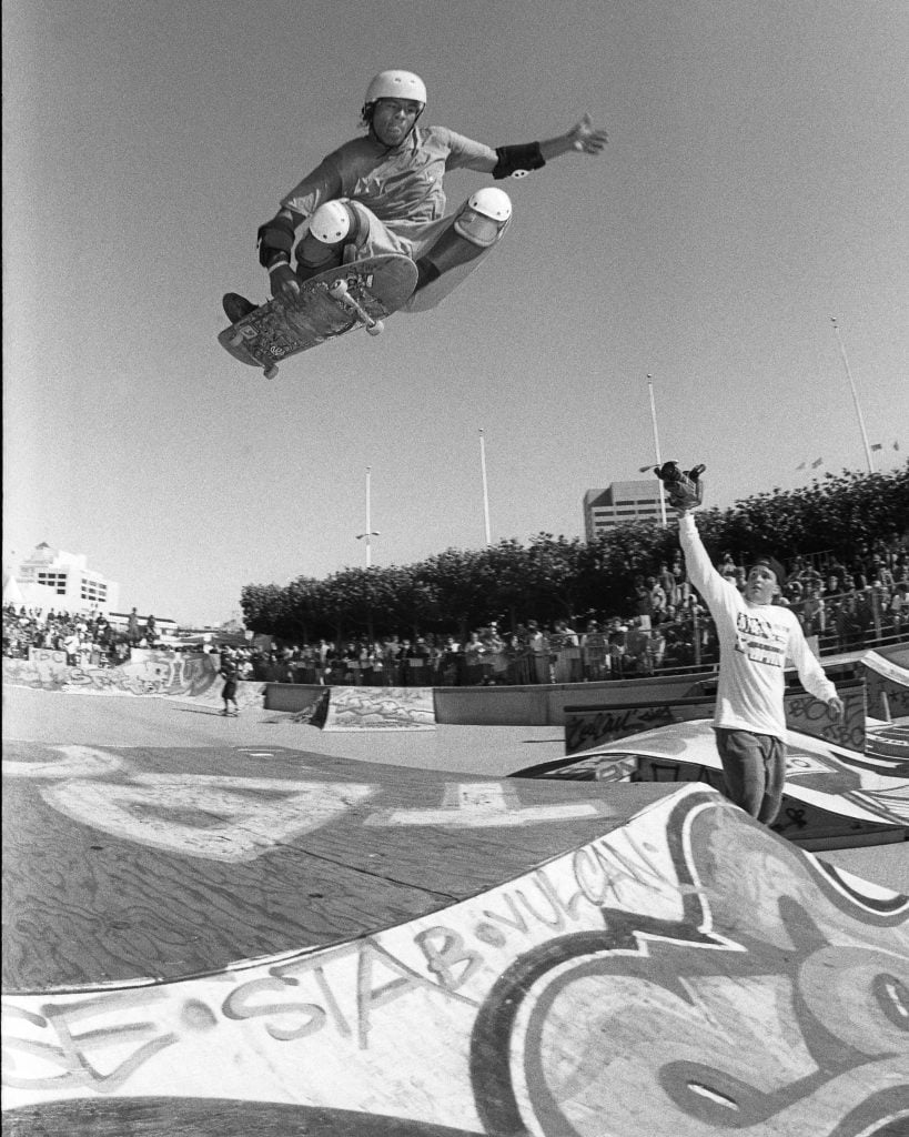 a black and white photo of a skater in the air 