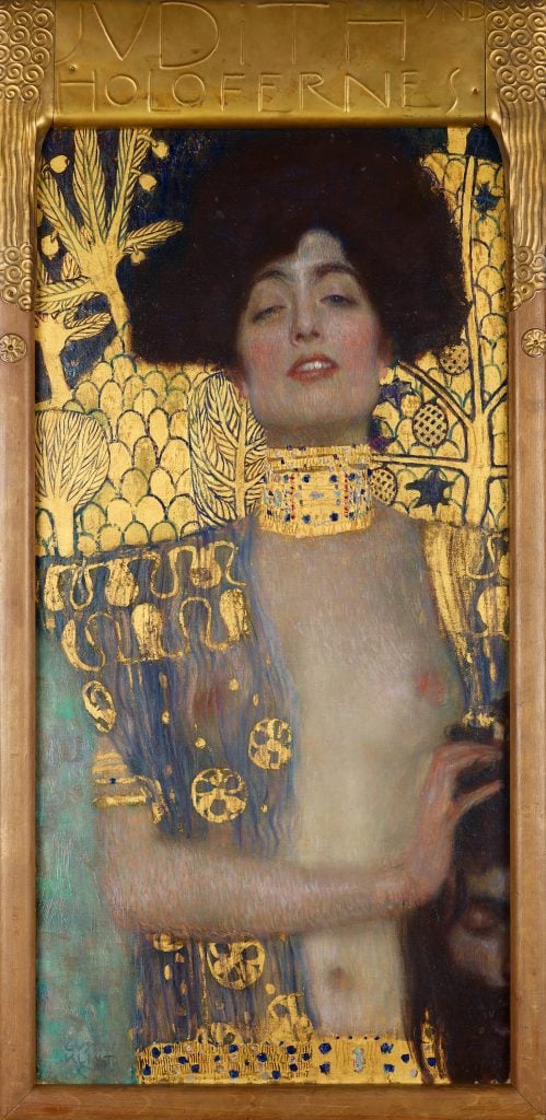 painting of a woman in a gold-adorned painting. the woman has a defiant stare and black hair. she wears a gold-ornamented blouse that is open at the chest and a gold choaker