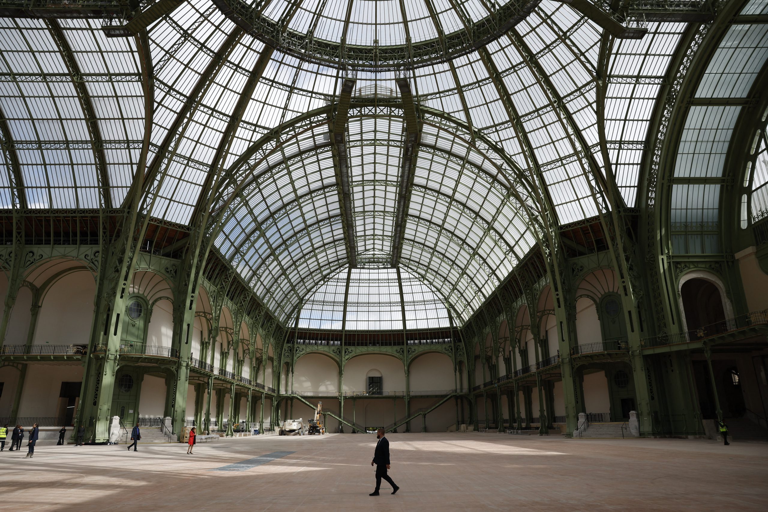 a man is walking inside the grand Palais