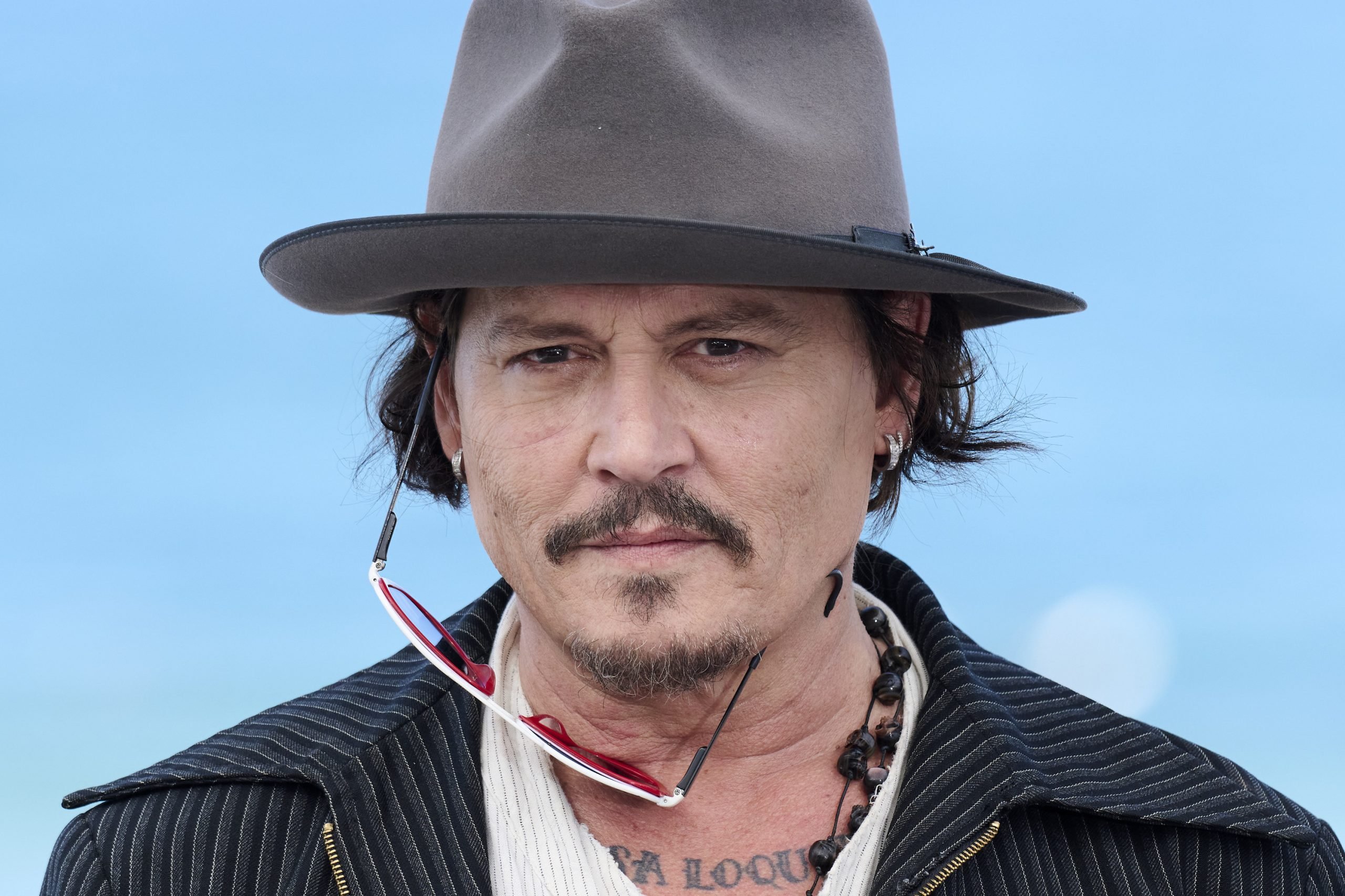 a man with a cowboy hat on a blue background