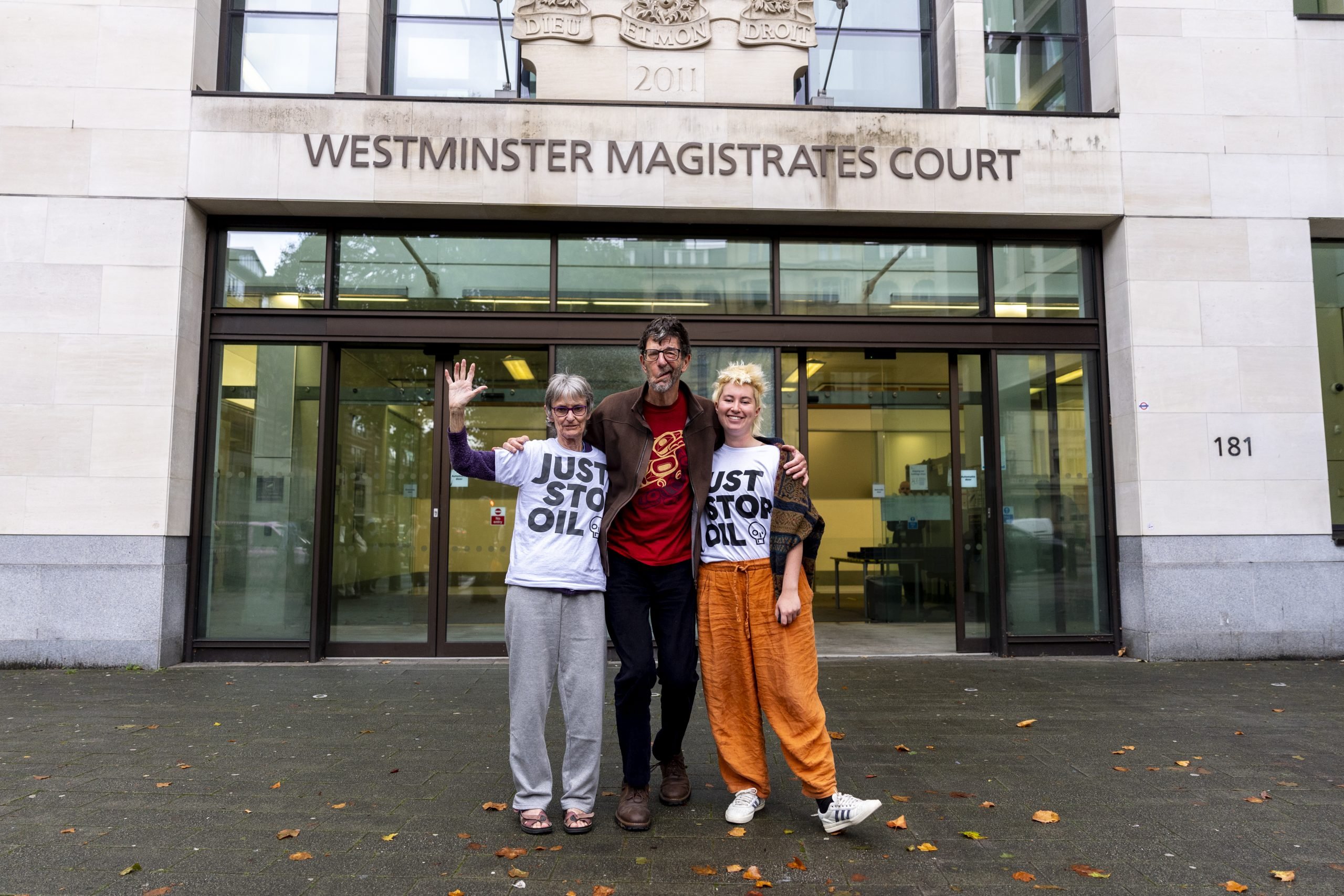 a picture of three people smiling outside of a courthouse