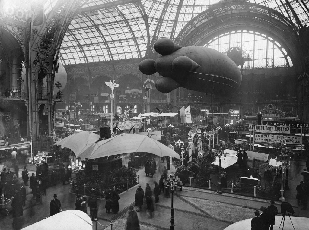 a large zeppelin is suspended insider of the grand Palais in Paris 