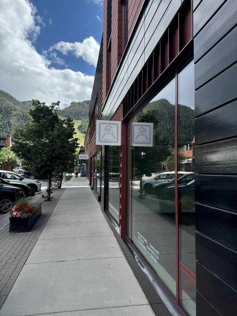 the facade of a business office in a mountain town