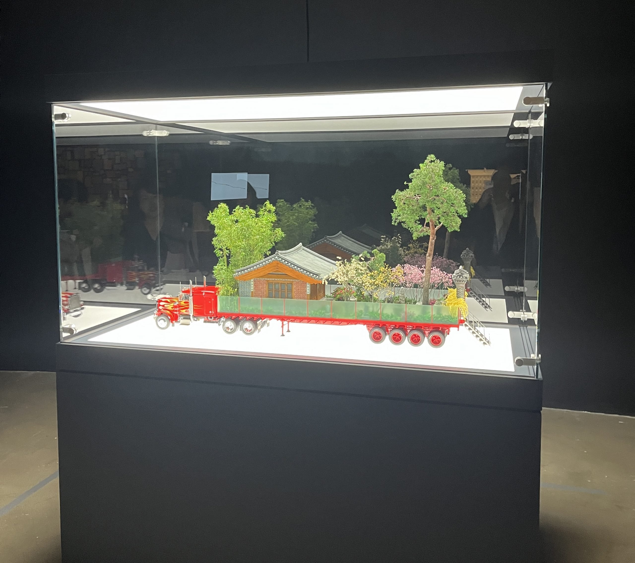 A model of a truck sits in a vitrine