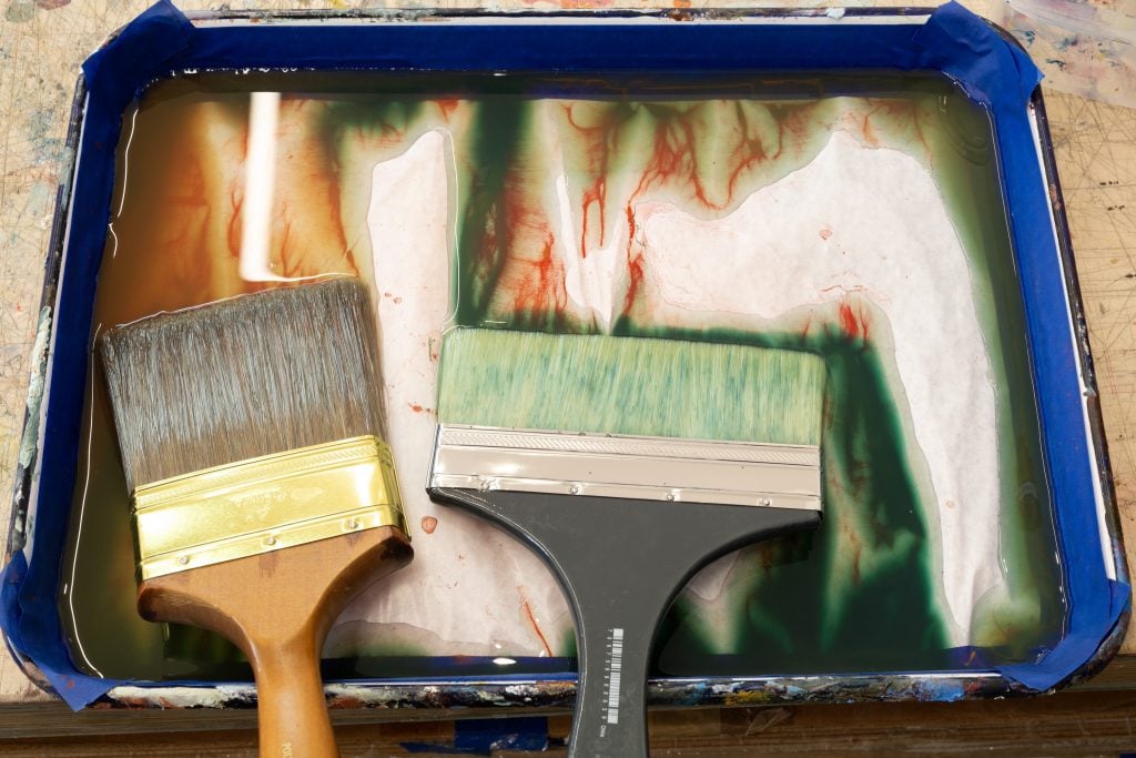 paint brushes in a paint dish