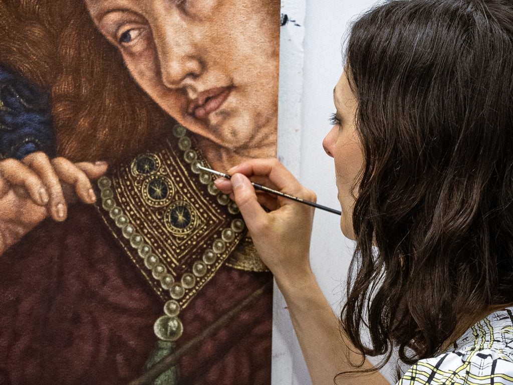 a woman with brown hair paints an old master stylepainting