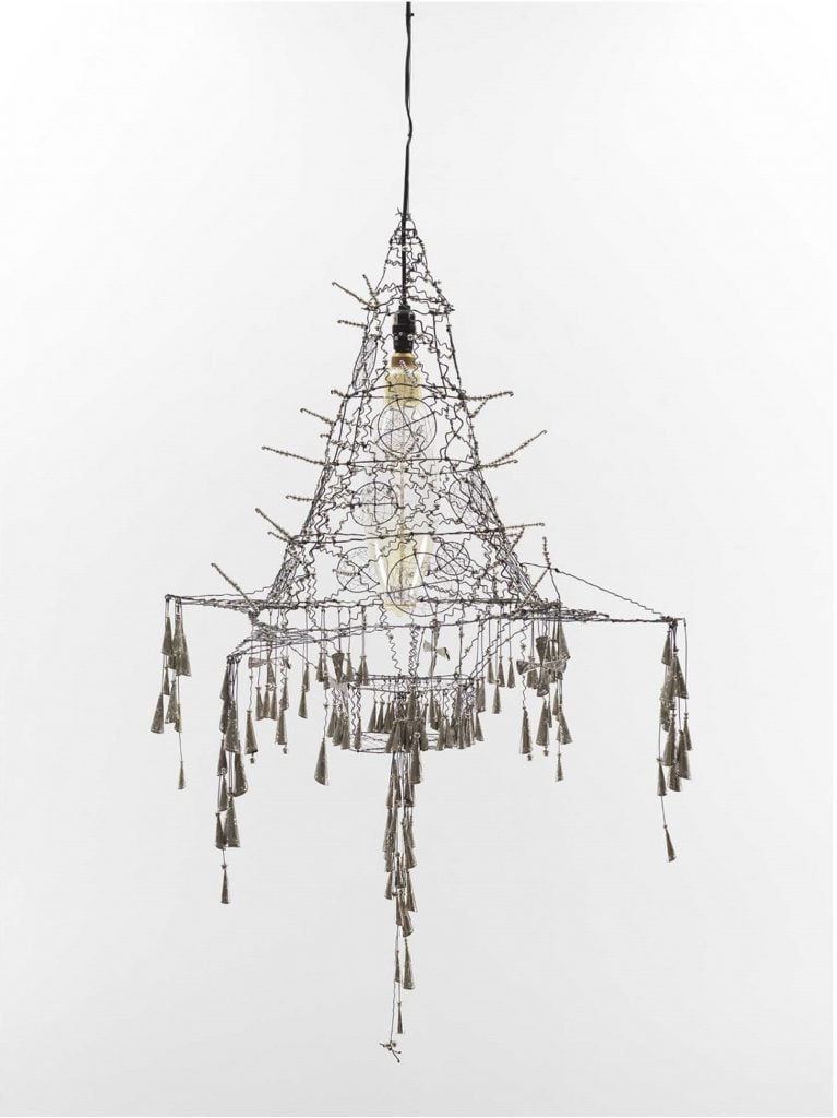 A chandelier crafted out of wire and hanging tassels