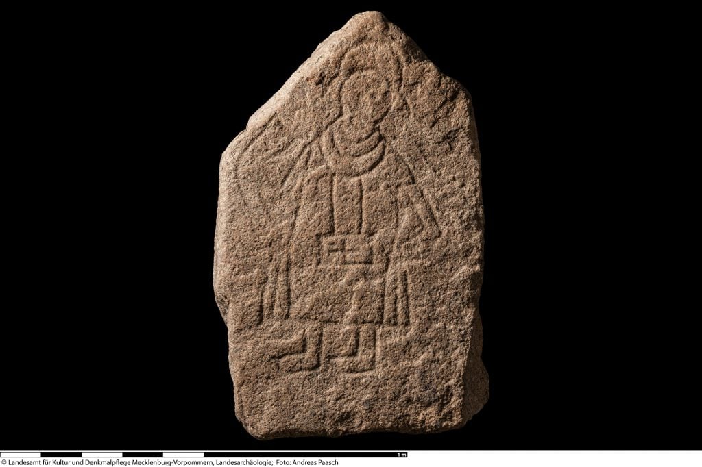 the picture stone on a black background you can see the markings of a figure