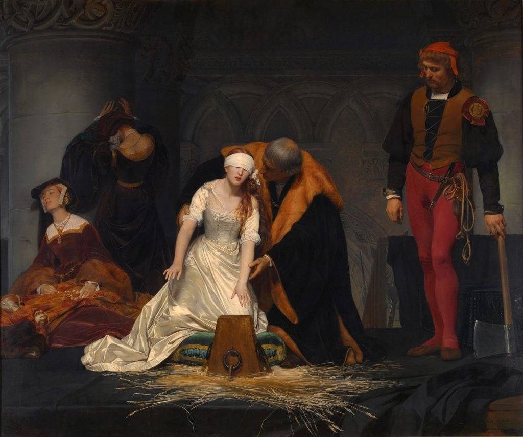 a woman with long red hair wears a white dress and blindfold in a prison room surrounded by other figures