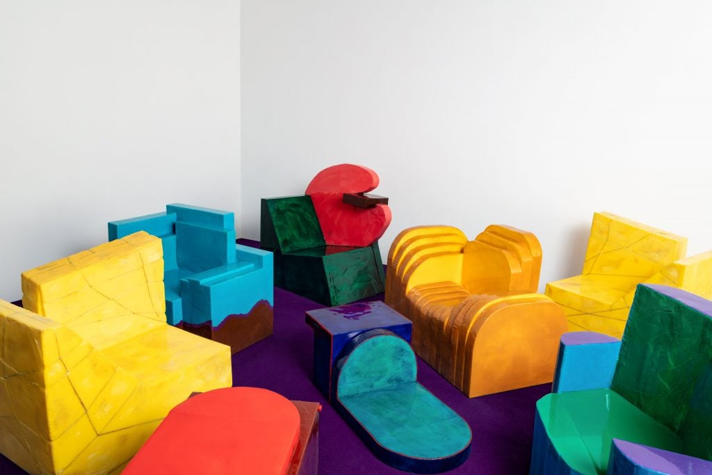 brightly hued designe furniture is on the floorof a gallery 