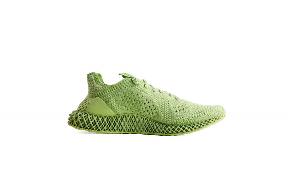 A photo of a green woven running shoe, facing to the right.