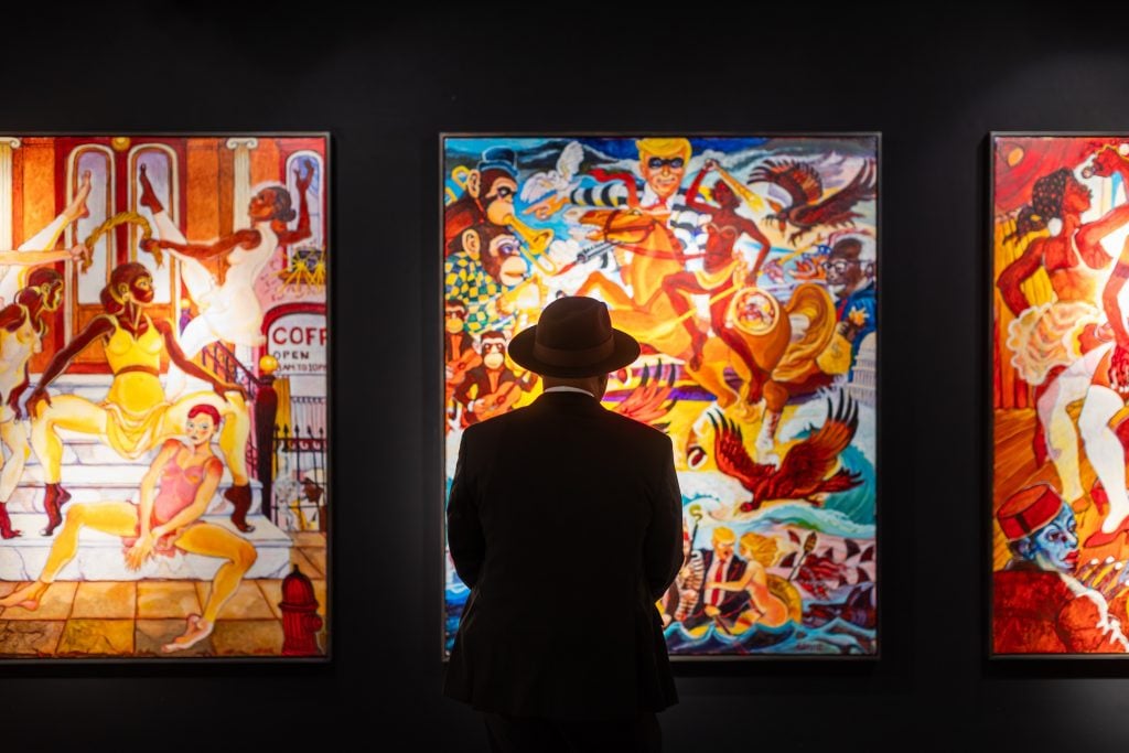 A man looks at an artwork