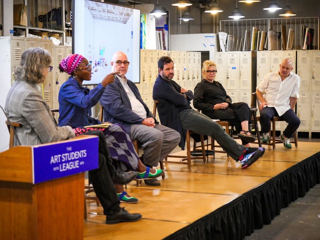 Six people seated on stage