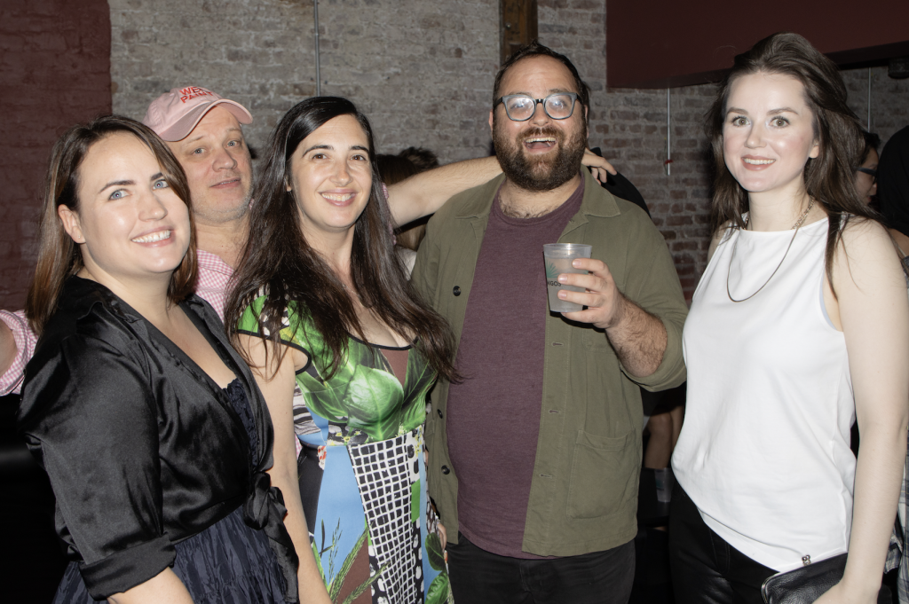 A photo of a group of four young writers at a party.