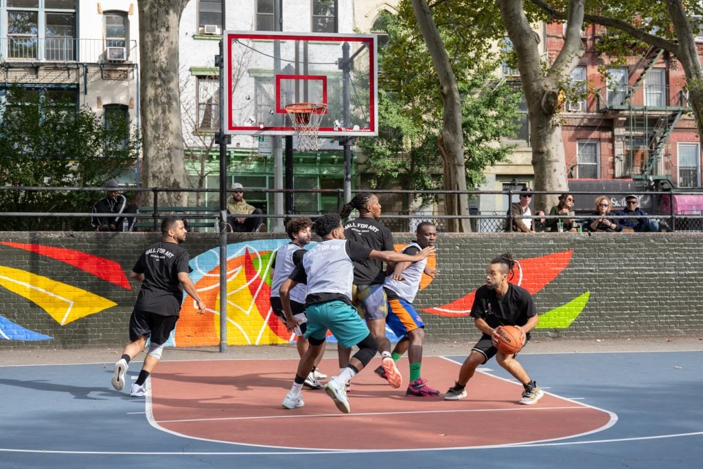 A photograph of an outdoor basketball tournament underway.