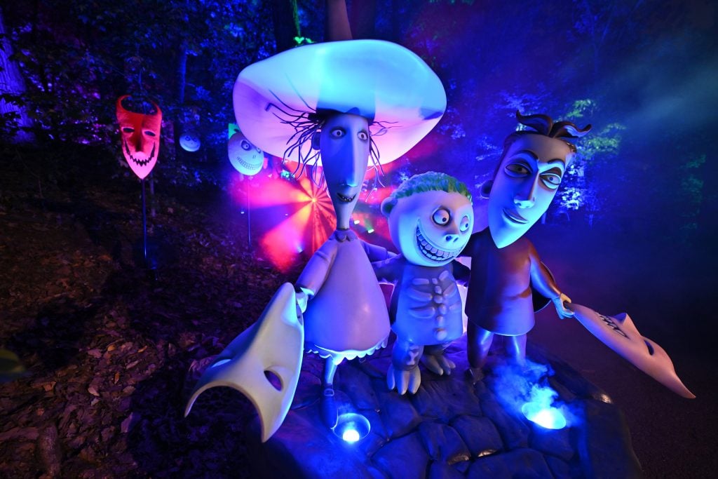 Figurines of creepy children from Tim Burton's film The Nightmare Before Christmas, illuminated by UV light