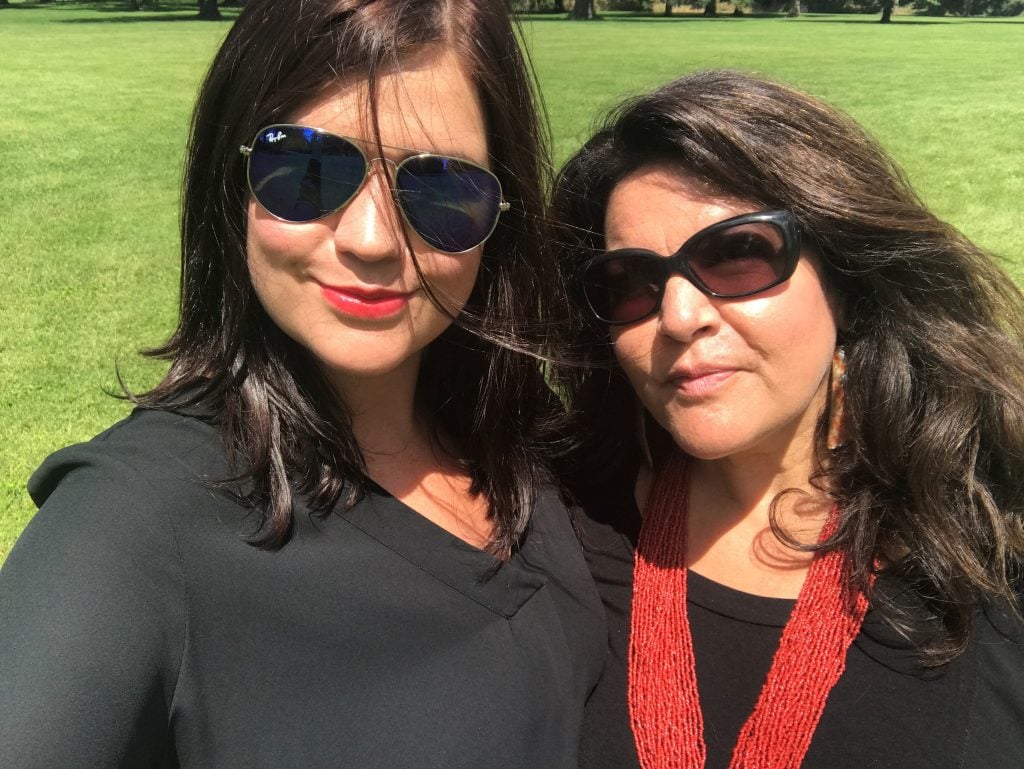 two women with dark hair take a selfie