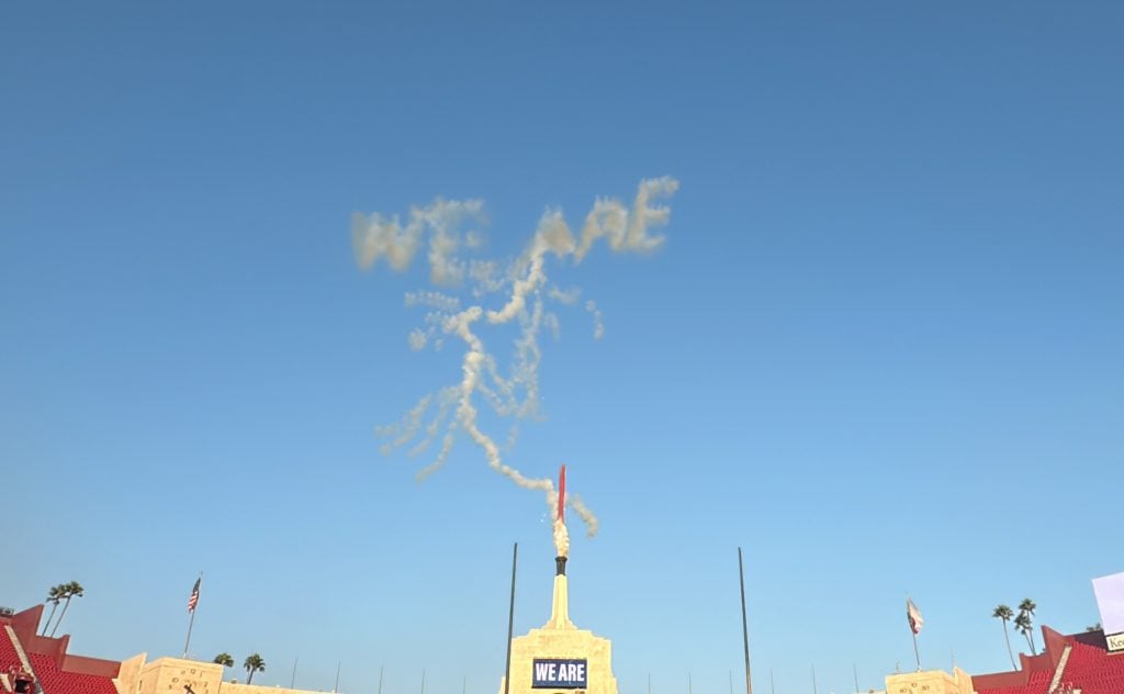 Fireworks spelling out "WE ARE" trailed by the outline of a lightning bolt