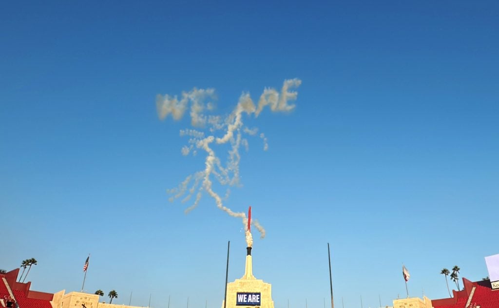 Fireworks spelling out "WE ARE" trailed by the outline of a lightning bolt