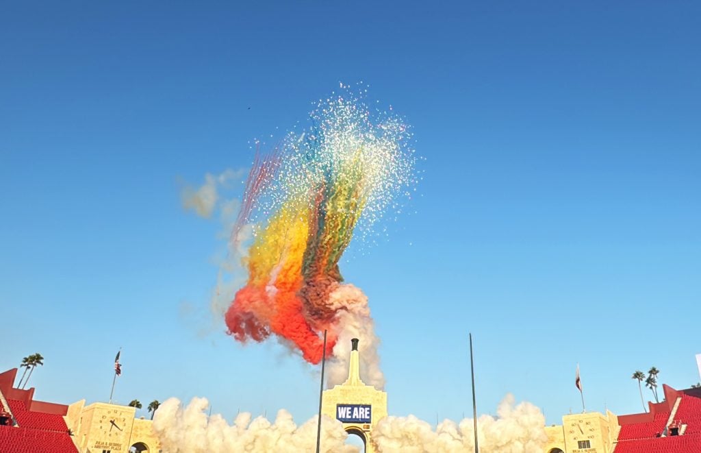 Colorful fireworks exploding above a stone arch