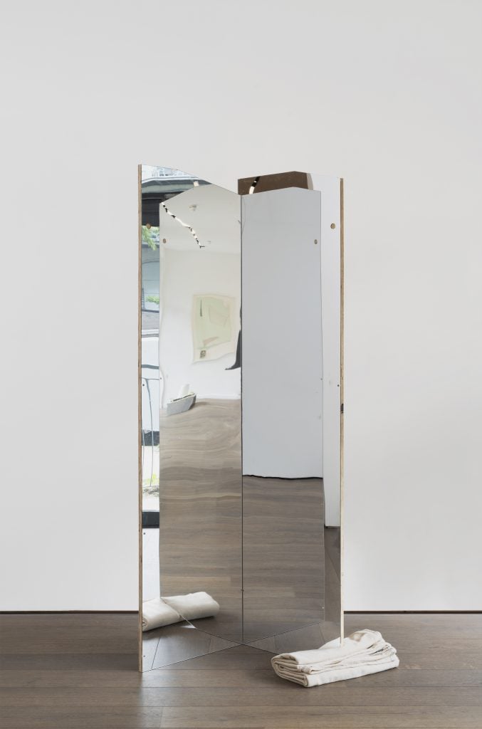 Artwork by artist duo Cullinan Richards of a standing mirror with two panes tilted slightly toward each other.