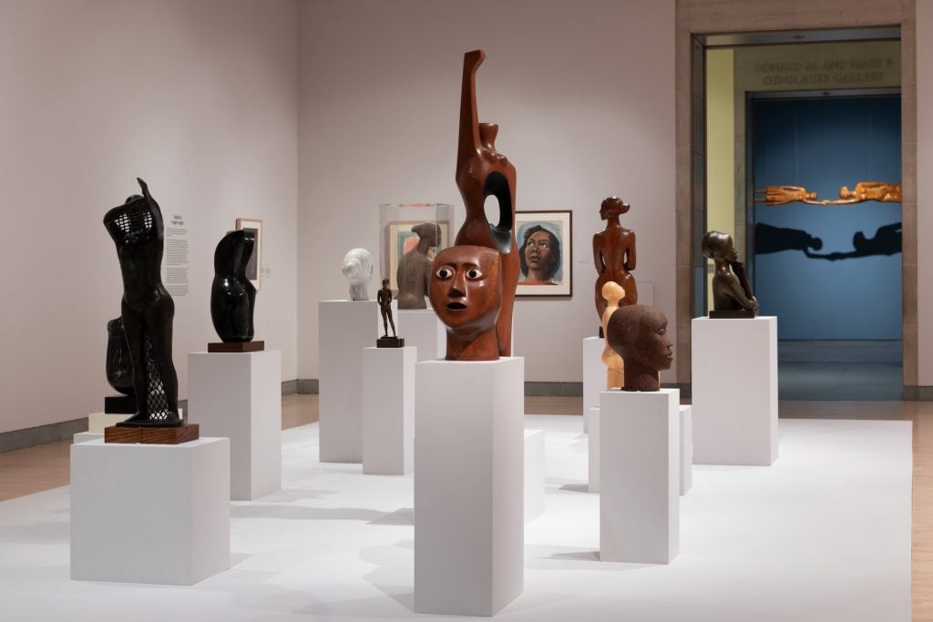 A gallery full of multiple sculptures on plinths