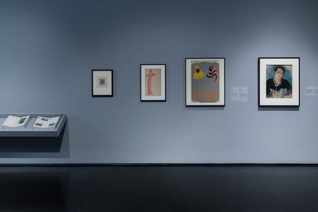 A gallery with multiple prints hanging on the wall