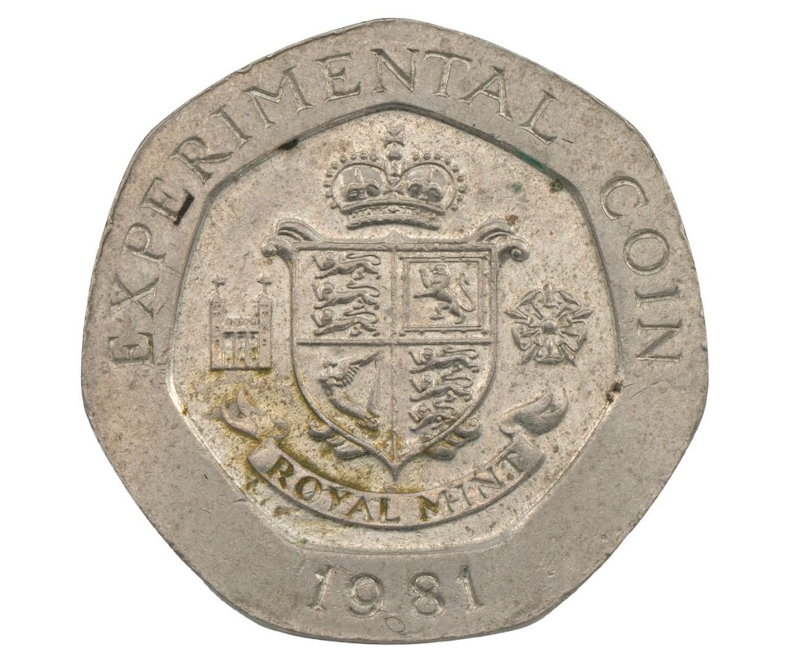 A seven-sided 20 pence coin that reads "experimental coin" and bears a crown and shield logo