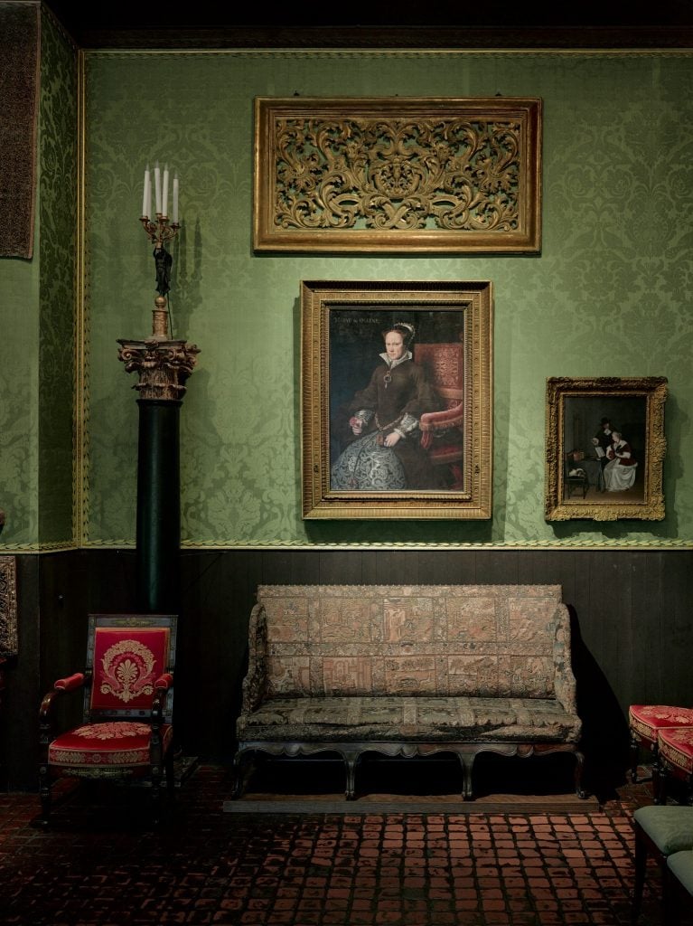 A lushly appointed room with paintings, sculpture and decorative arts