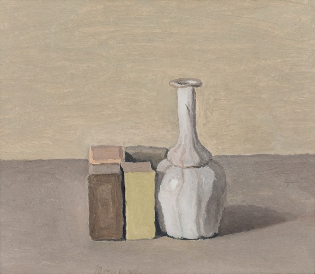 A still life by Giorgio Morandi featuring a series of small rectangular objects upright next to a white porcelain vase.