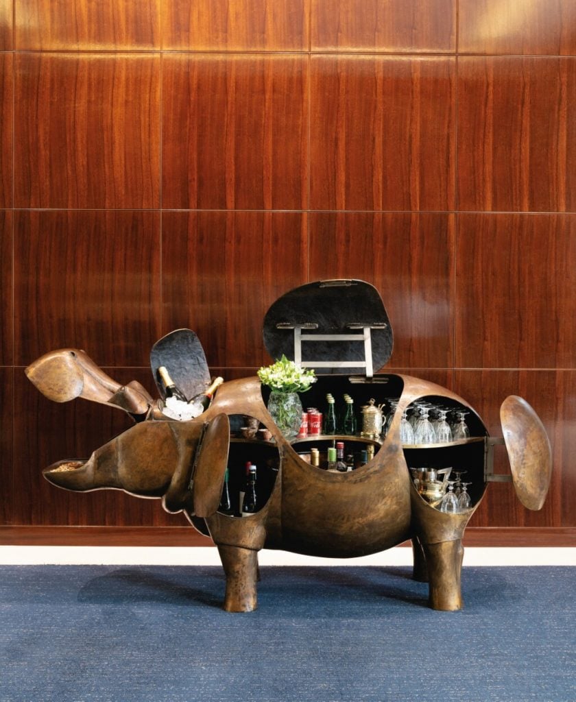 A bronze sculpture of a hippopotamus has hidden doors that open to allow it to function as a bar