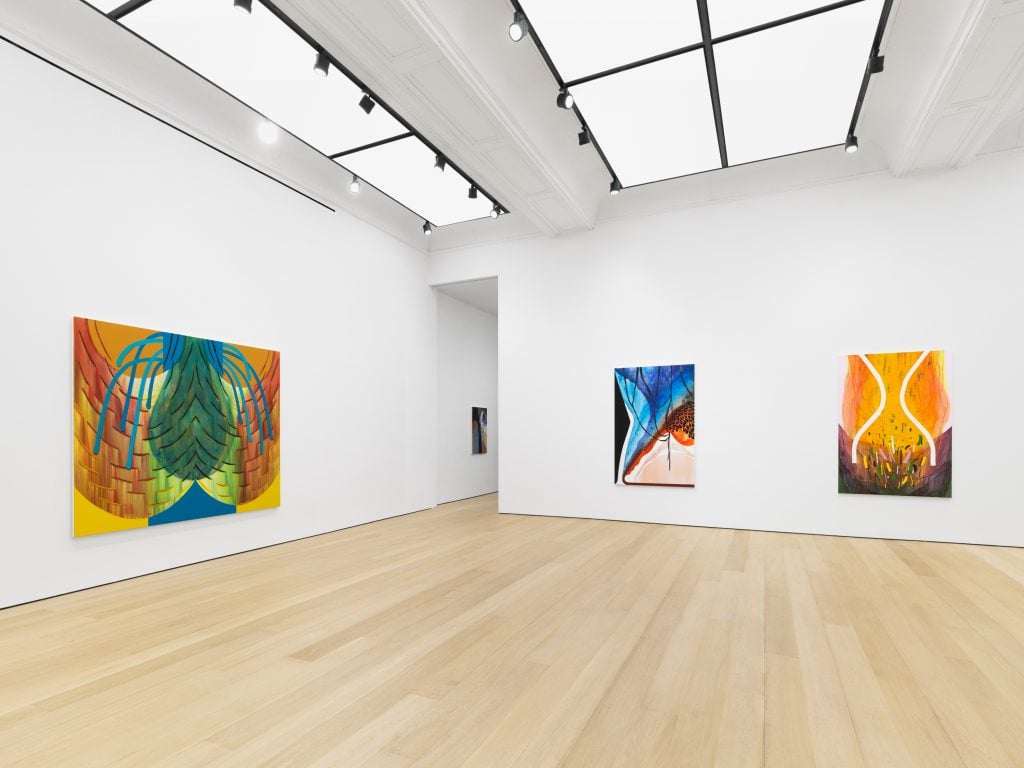 Installation view of Carrie Moyer solo show titled "Timber!" showing three abstract paintings installed in a white gallery space.