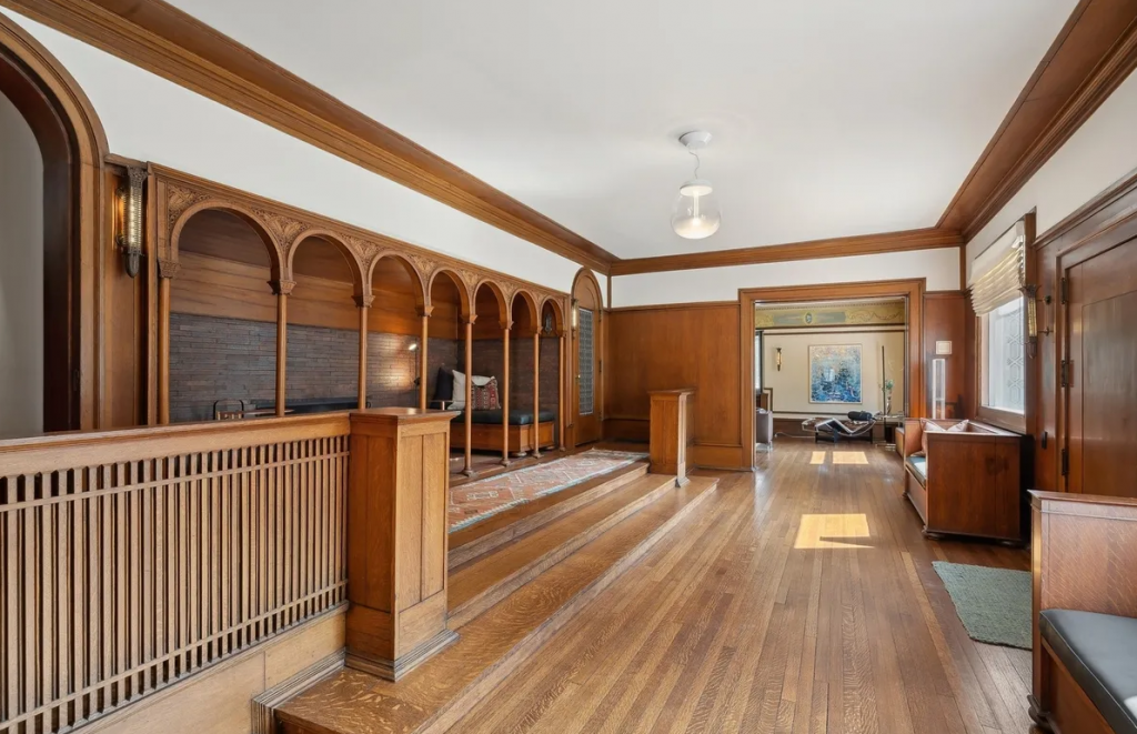 an interior of the house with wooden floor and a nook to the left hand side