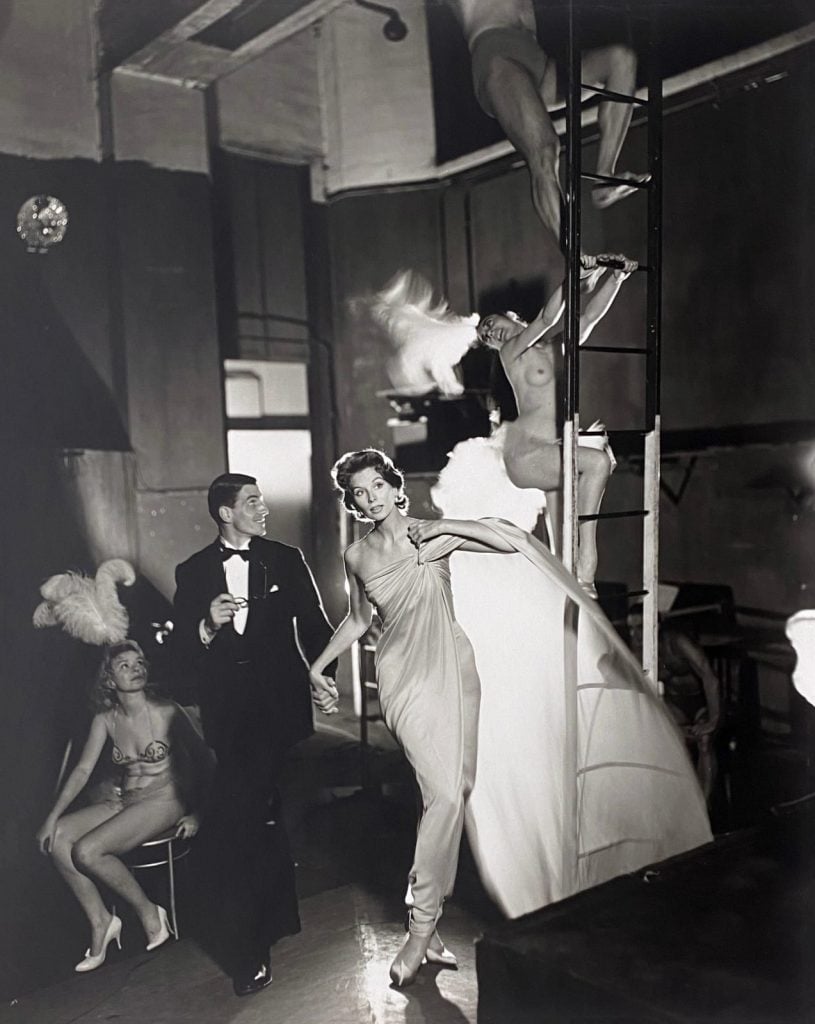 Black and white photo of several models on a vintage stage set.