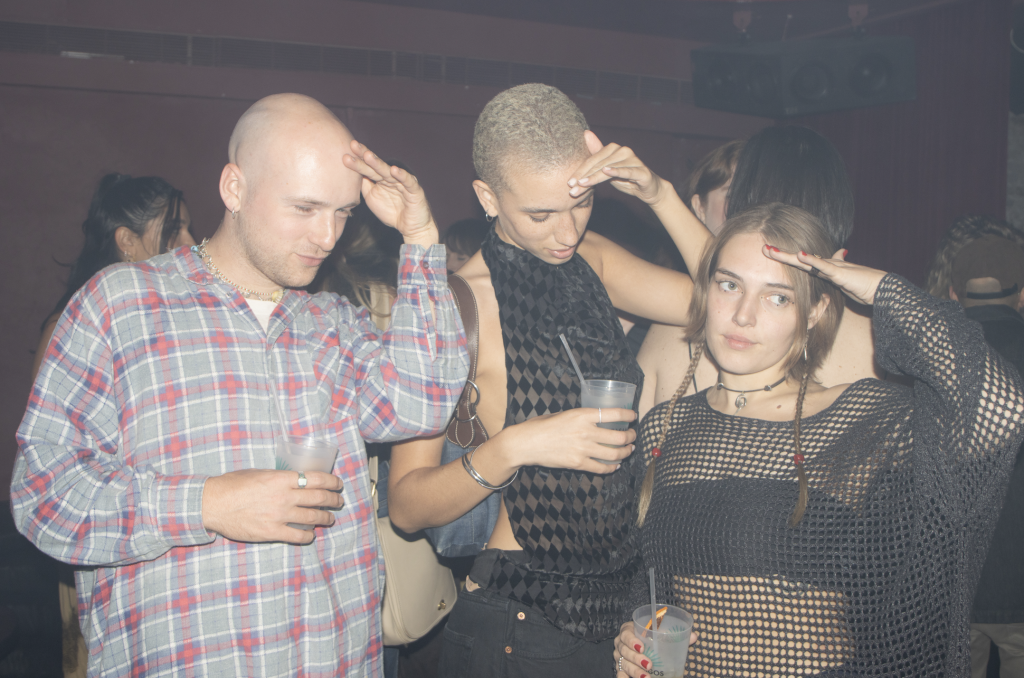 A photo of three young partygoers striking a pose.