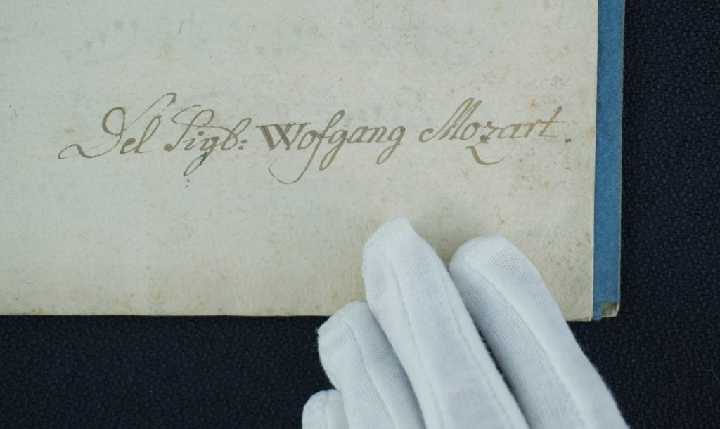 Close up of a manuscript bearing the words "Wofgang Mozart"