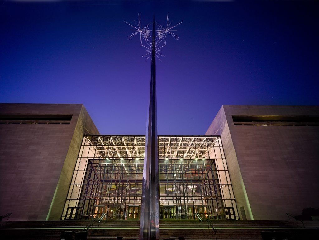 The entrance of a museum at dusk