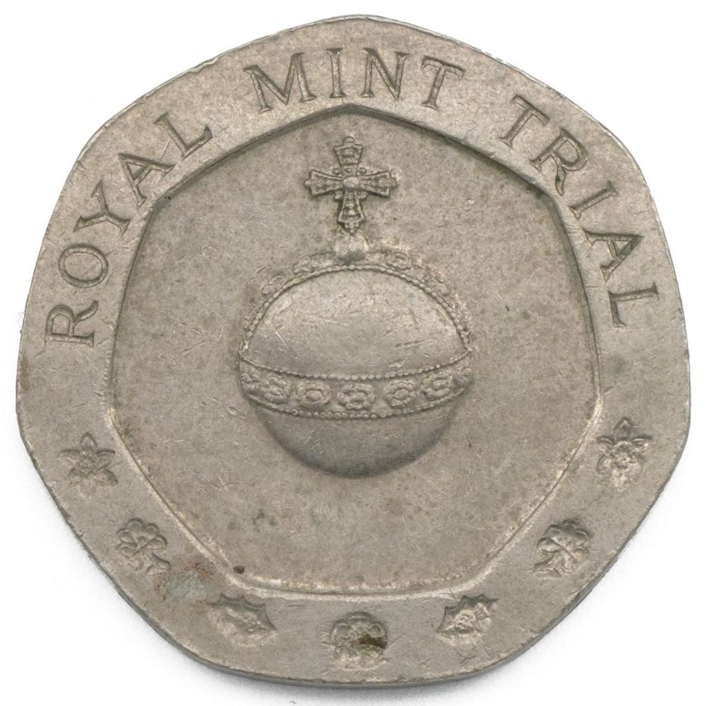 A coin that reads "Royal Mint Trial" above the Sovereign's Orb, or on orb with a crown on top