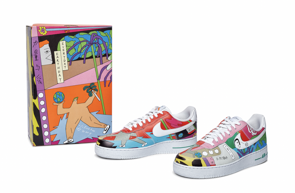 A photo of two pairs of colorful low-rise Nike sneakers, with an equally colorful box and semi-abstract scene on it to the left.