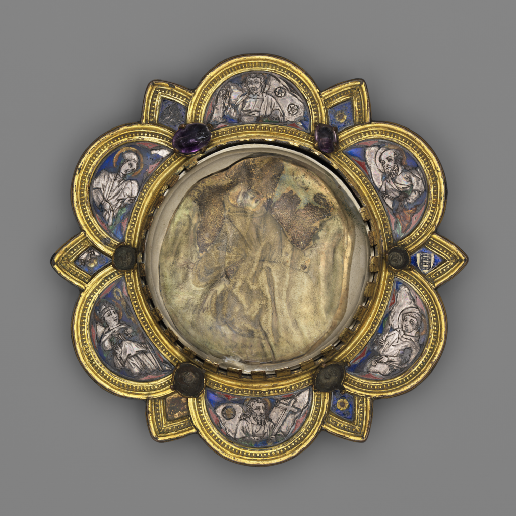 A photo of a gilded copper, silver, and enamel flower-shaped broach with a scene of St. Francis receiving stigmata at its center, on a grey background.